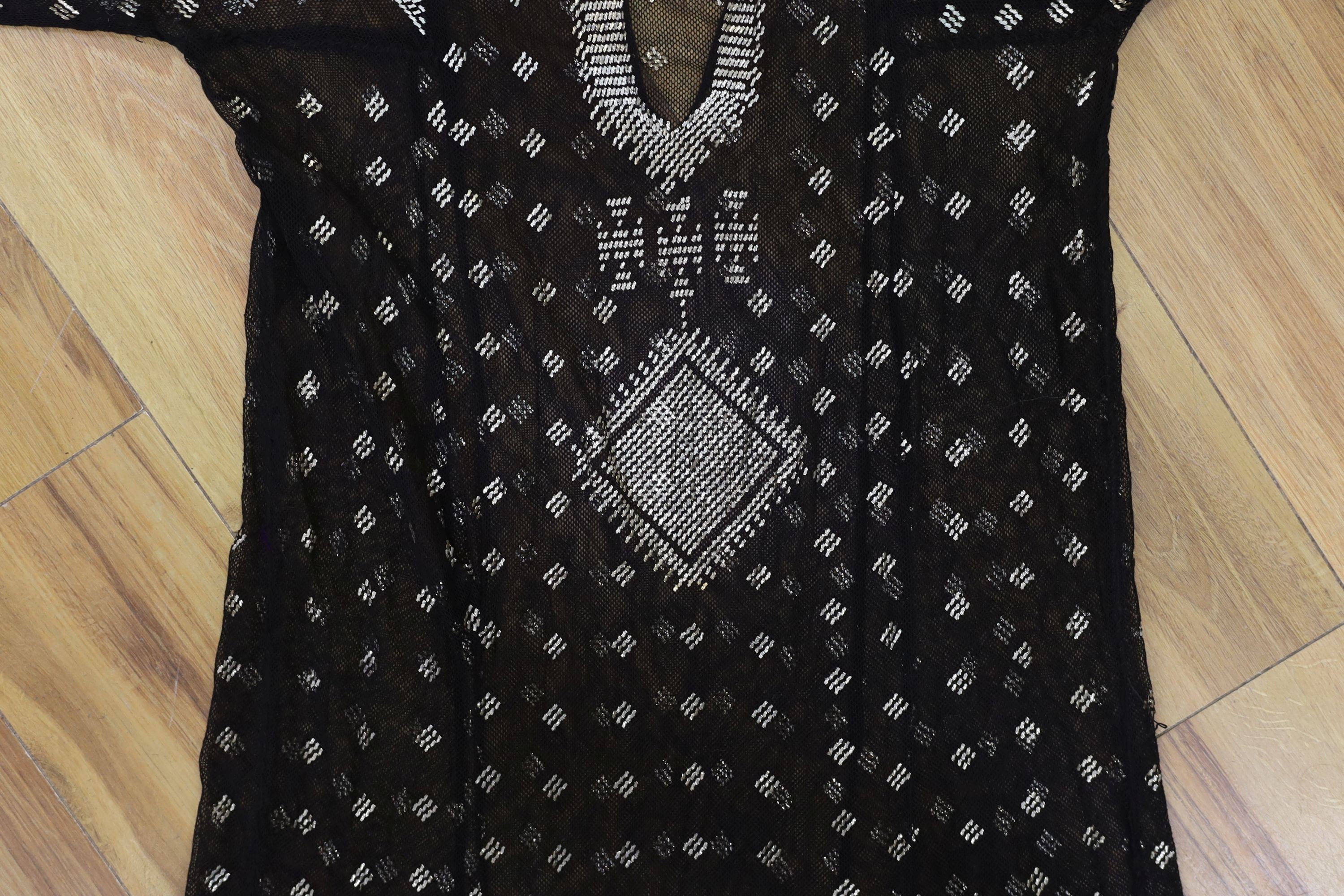 A dress made from a metal and black net Egyptian shawl; a similar shawl and a piece of shawl